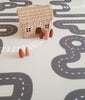 Wooden toys on Earl Grey Baby Driver playmat. Side B has a car track design.