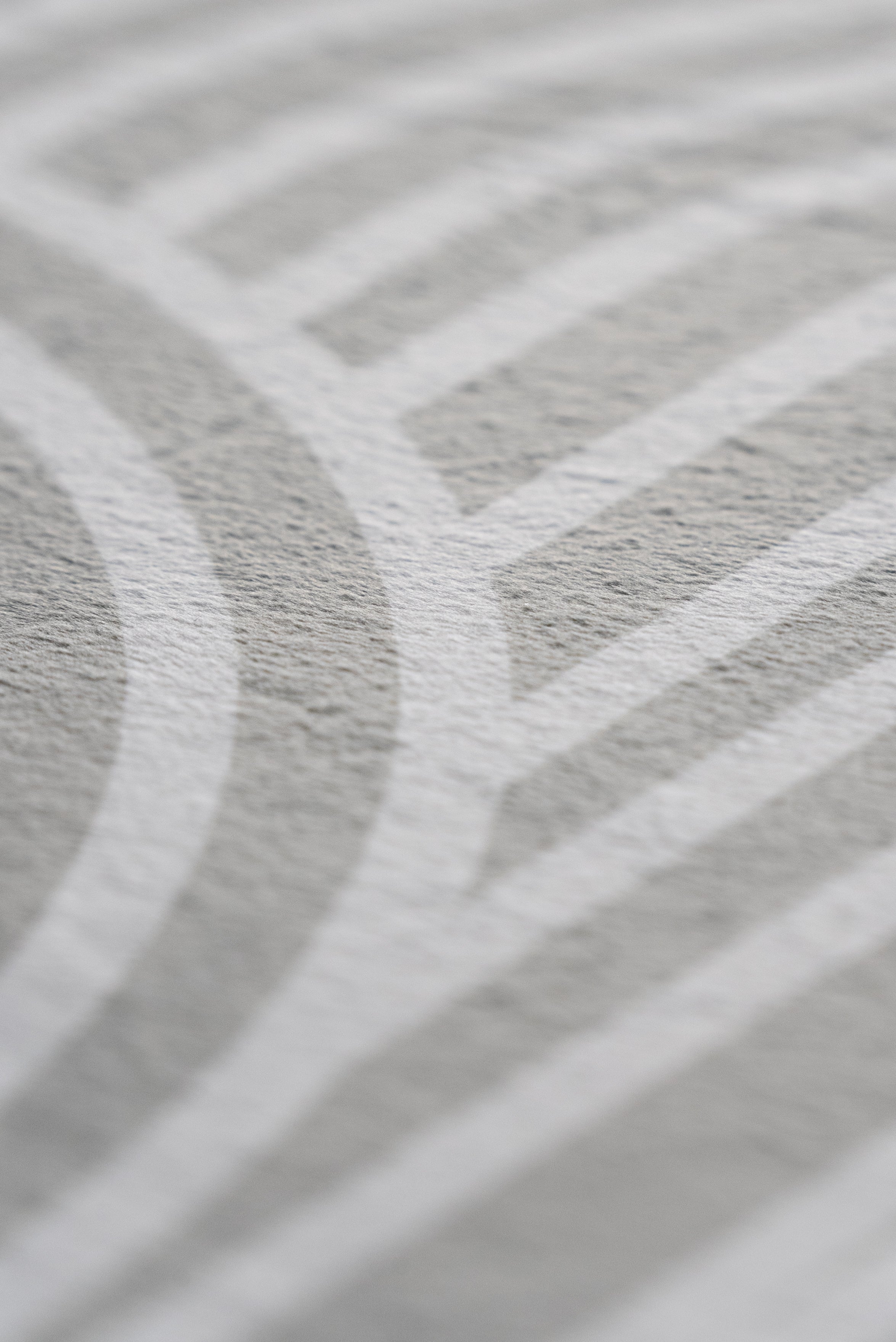Close-up image highlighting a white and grey pattern, emphasizing its delicate design and visual depth.