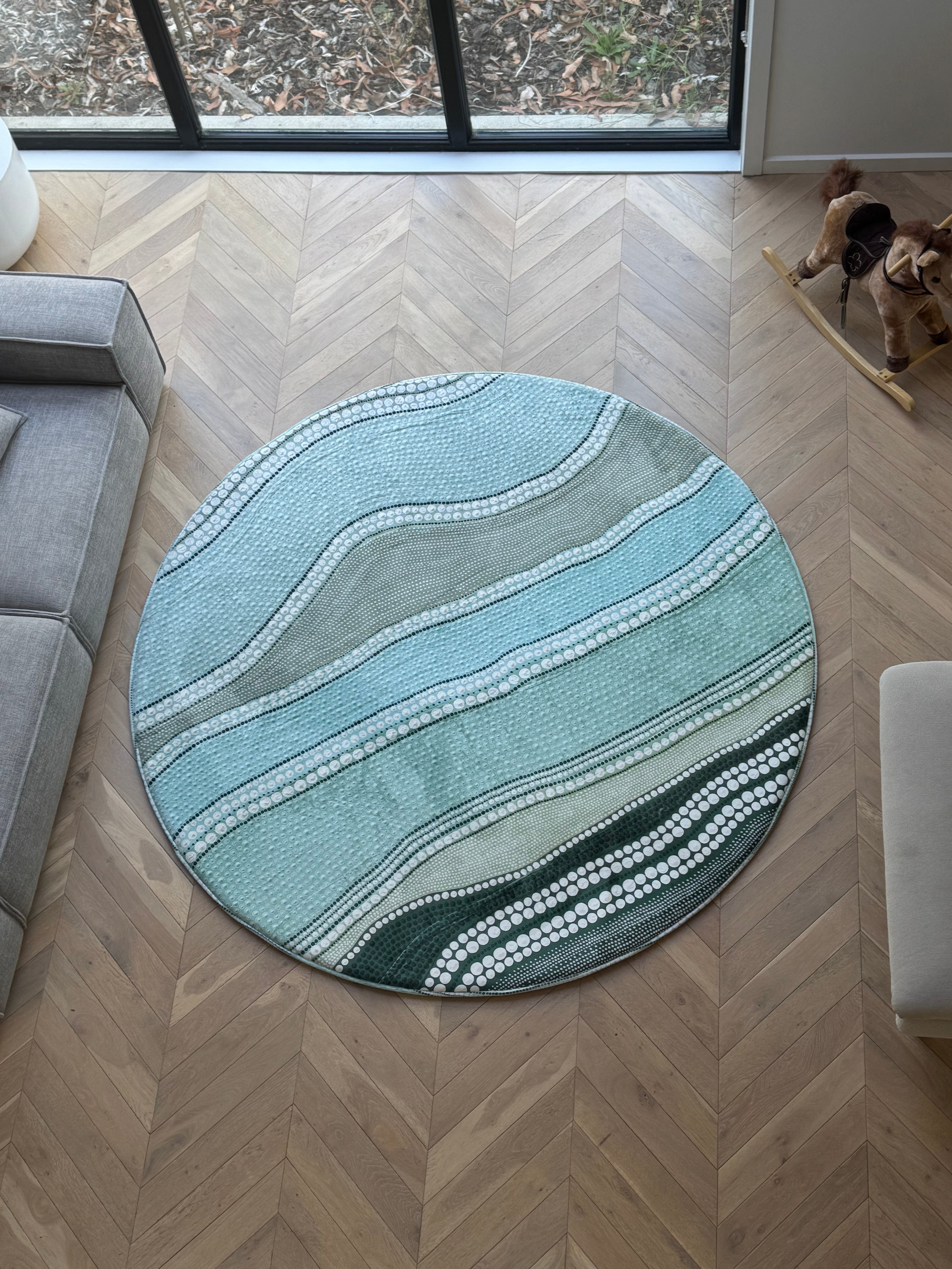 A round rug memory foam tatami with ocean reef artwork placed in a cozy ...