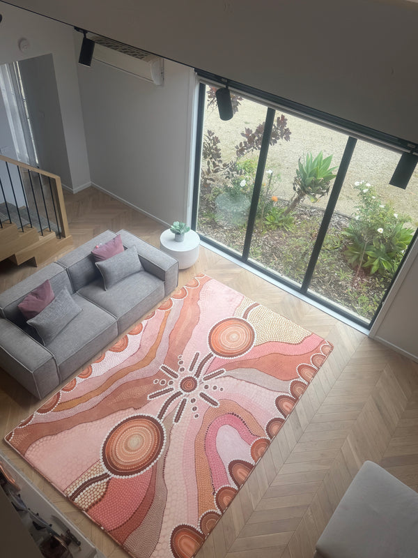 A patterned rug covering the floor in a living room, contributing to the room's overall aesthetic.