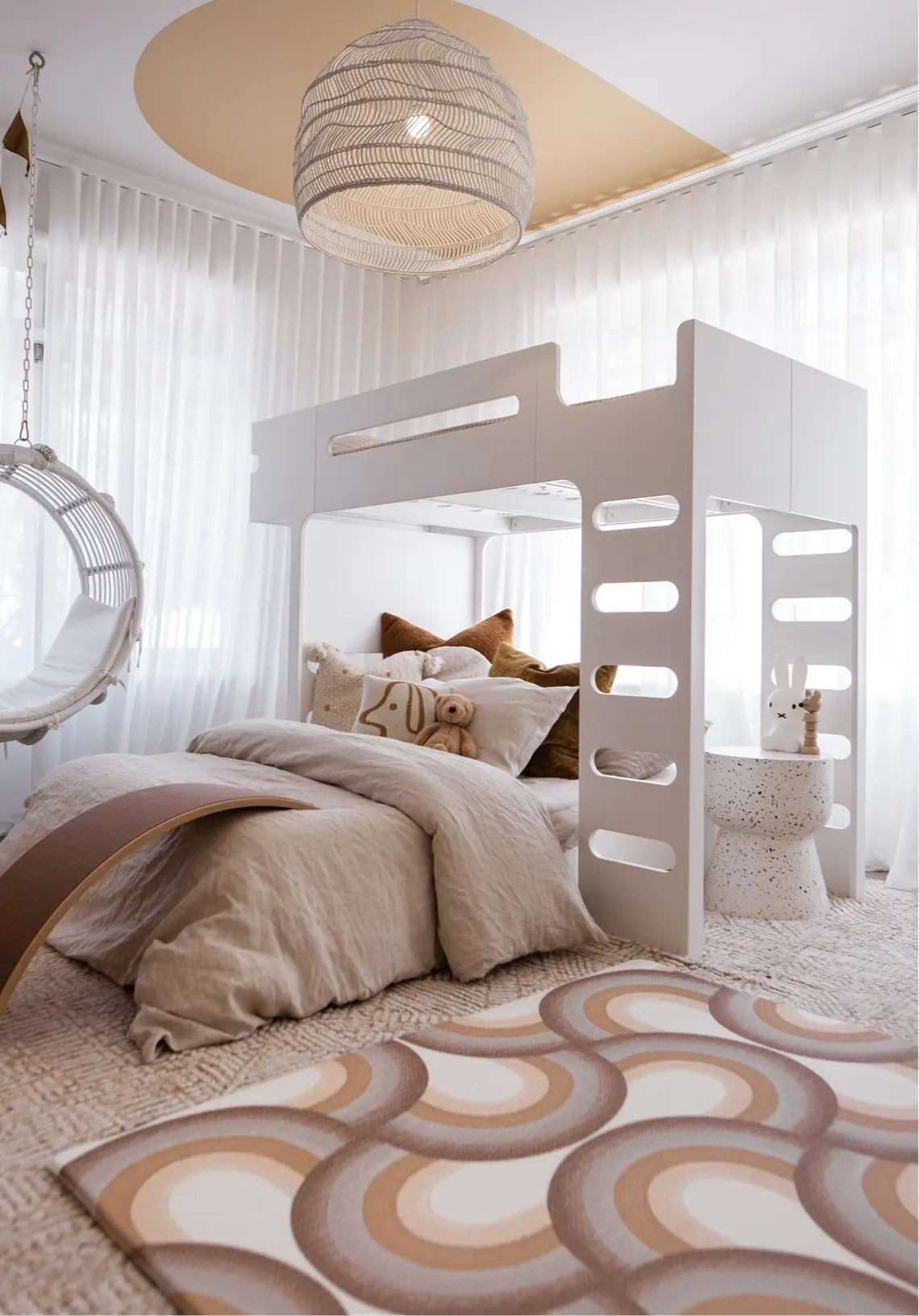 Kids bedroom showing the Archie Retro Large Playmat on the floor. Side A of the playmat shows a brown arch pattern.
