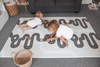 Kids playing on the Baby Driver Boho large playmat with wooden cars. Side B has a track design.