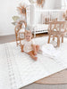 Girl playing on the Baby Driver Boho large playmat.