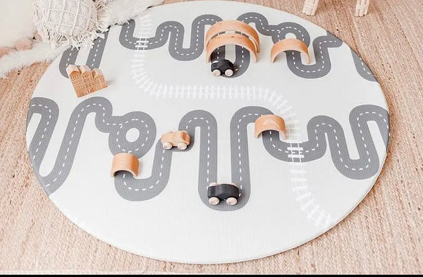 Wooden toys on Baby Driver Earl Round playmat. Side B has a car track design.