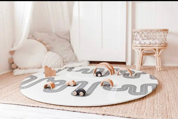 Wooden toys on Baby Driver Earl Round playmat. Side B has a car track design.