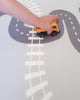 Wooden toy on Baby Driver Grey Boho playmat. Side B has a car track design.