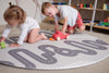 Kids playing with wooden toys on Baby Driver Grey Boho round playmat. Side B has a car track design.