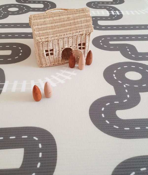 Wooden toys on Baby Driver Neutral playmat. Side B has a car track design.