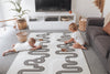 Kids playing with wooden toys on Baby Driver Grey Boho playmat. pattern and side B has a car track design.