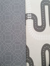 Two sides of Earl Grey Baby Driver playmat. Side A has a grey geometric pattern and side B has a car track design.