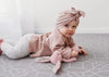 Baby doing tummy time on My name is Earl Large Grey playmat. Side A grey geometric pattern.